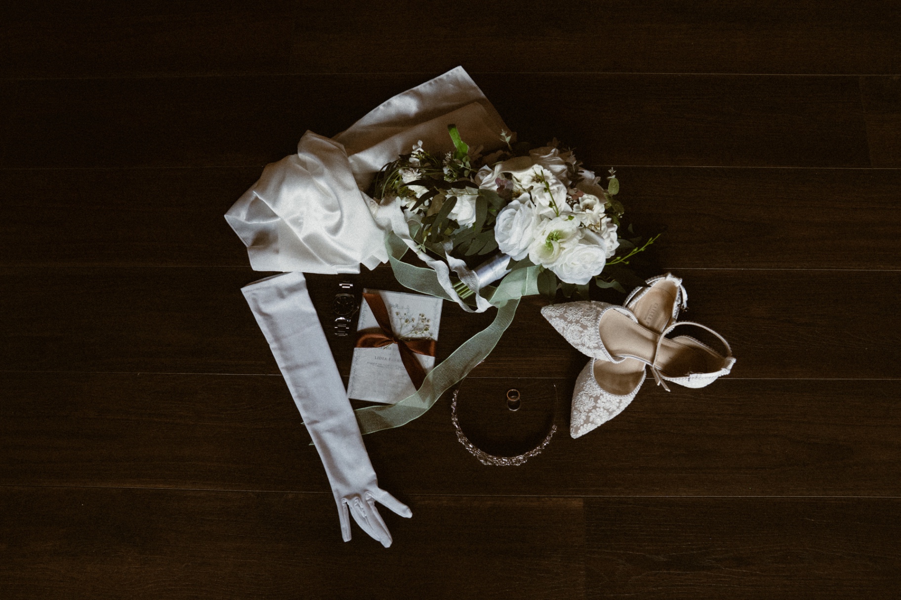 Bridal accessories on dark wood floor