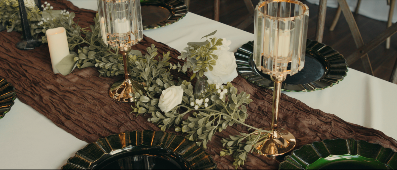 Wedding table with brown gauze runner and emerald plates